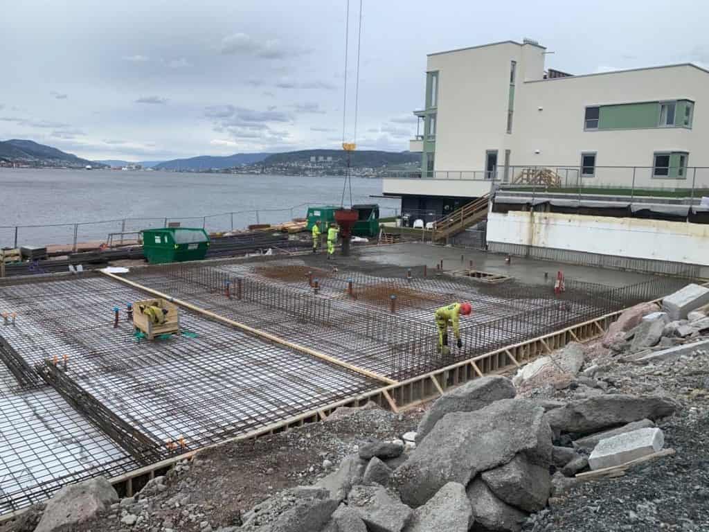 Reinforced concrete foundation construction for waterfront building by Trio Betong, showcasing quality assurance and expertise in concrete pouring and reinforcement installation.