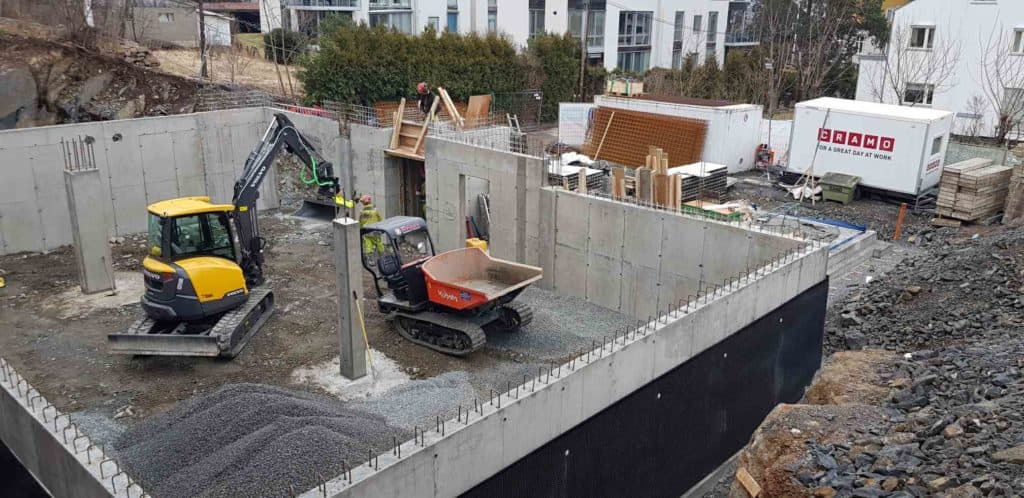 Excavation site with concrete foundation and construction equipment for Trio Betong project, showcasing innovative concrete solutions and strong construction expertise.