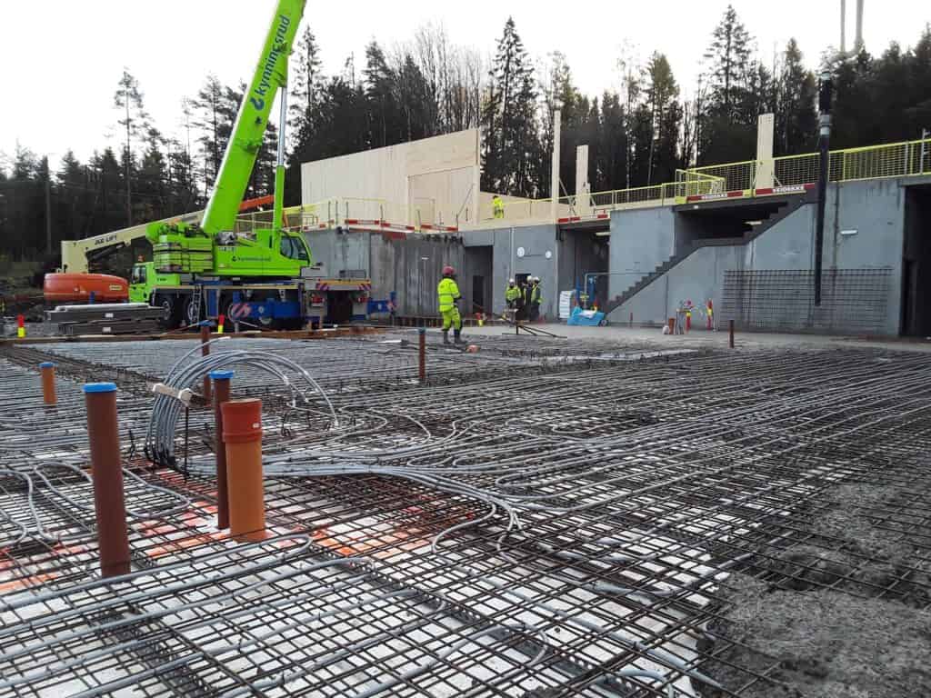 Reinforced concrete construction site with steel rebar framework for foundation work.