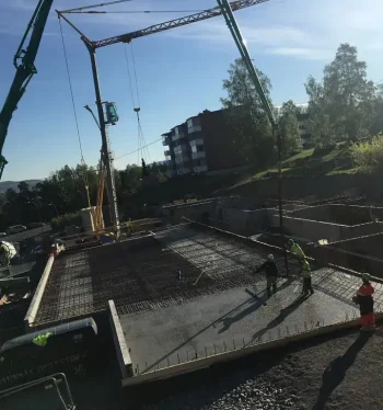 Reinforced concrete foundation being poured at a construction site by Trio Betong for a building project.