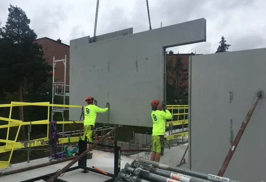 Precast concrete wall panel installation at construction site by Trio Betong, quality construction materials, expert onsite workers.